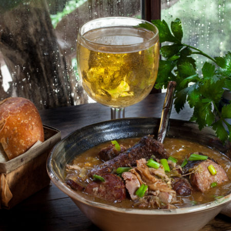 Succulent morsels of pork clinging tenderly to the bone swim in a bowl of dark roux-based gravy. (All photos credit: George Graham)