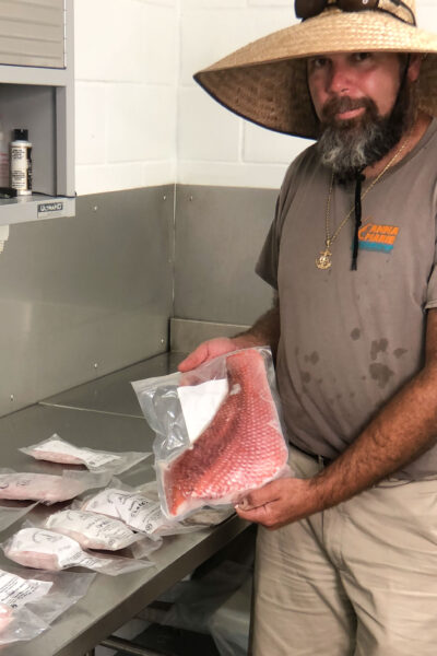 Lance with a vacuum-packed red snapper fillet. (photo credit: George Graham)