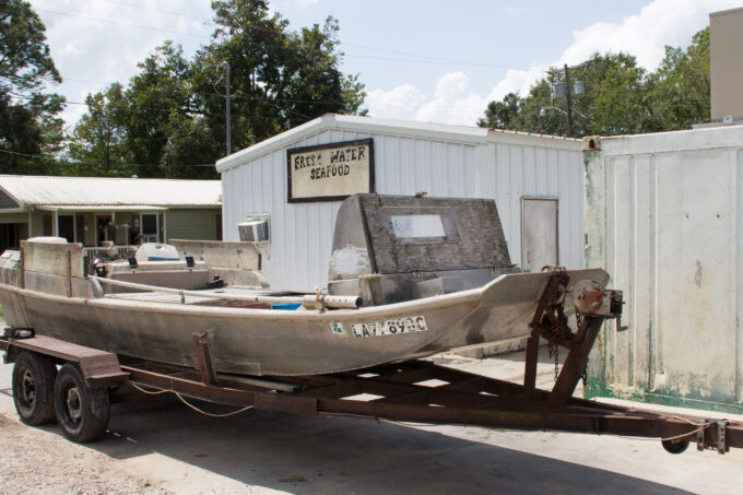 Boats pull up in front of the processing facility. (Photo credit: George Graham)