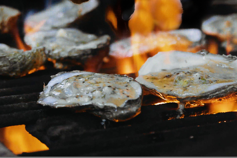 Smoked and flames add flavor to these oysters. (Photo credit: George Graham)