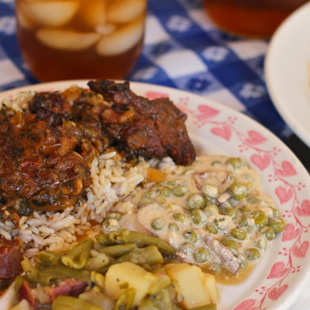 Smoked Turkey Leg Stew over White Rice with Tasso-Spiked Green Beans and Sweet Peas in Garlic Cream