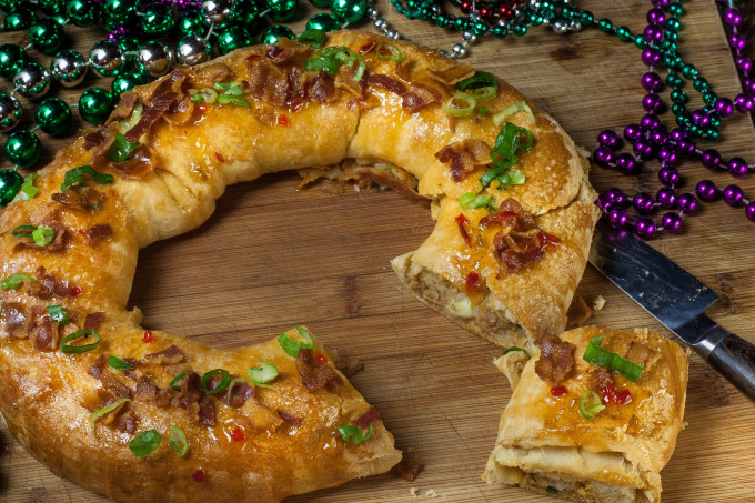 Cheese-stuffed boudin regally encased in crusty pepper jelly-glazed bread is a creative Cajun recipe for Boudin King Cake.