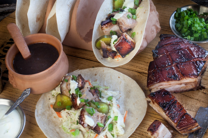 Pork Belly Tacos Pork Belly tacos served up tangy and sweet glazed with root beer on a bed of creamy slaw--a tasty Cajun recipe. (All photos credit: George Graham)