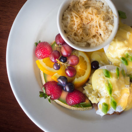 Poached Eggs over Fried Green Tomatoes with Crabmeat Hollandaise and Gouda Grits