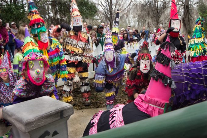 Colorfully dressed Mardi Gras revelers beg for Cajun recipe ingredients for their celebration gumbo.