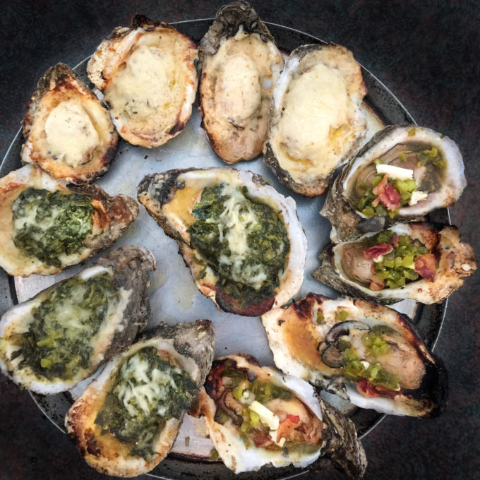 Oysters cooked three ways Clockwise from top: Shuck-a-fella, Roughneck, and Rockefeller oysters share the plate.