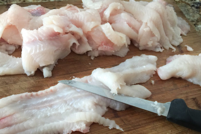 Thin-Cut Fried Catfish with knife A razor-sharp boning knife makes the job easy in this simple Thin-Cut Fried Catfish recipe.