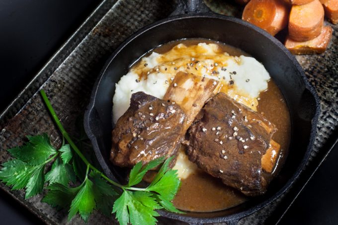 The rich, earthy flavors of beef ribs bathed in a dark coffee-infused gravy.