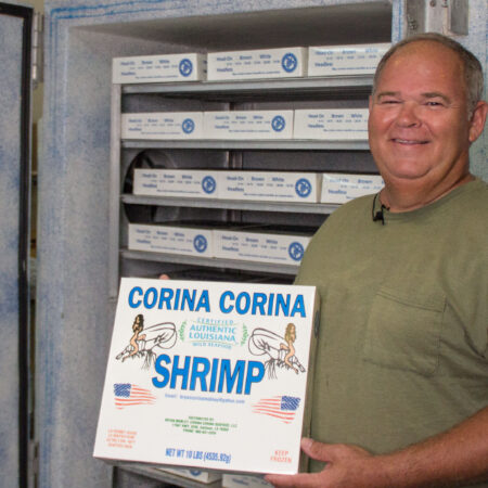 Shrimper Bryan Mobley with a 10 lb. box of his plate-frozen shrimp. (Photo credit: George Graham)