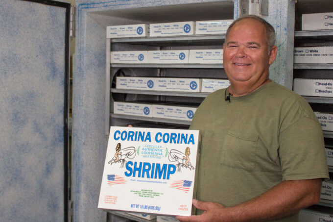Shrimper Bryan Mobley with a 10 lb. box of his plate-frozen shrimp. (Photo credit: George Graham)