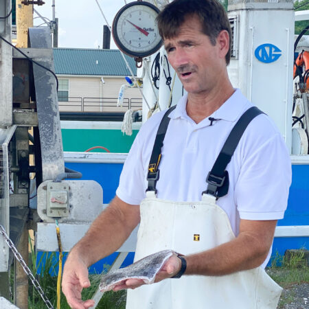 Douglas Olander tells how he brings black drum from boat to table. (Photo credit: George Graham)