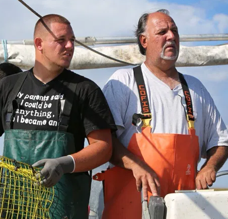 Timmy Luke (right) and his son Andi (left) fish the coastal waters for blue crabs. (Photo credit: Luke family archive)