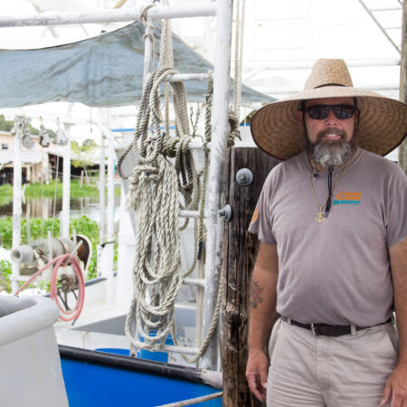 Lance Nacio stands dockside by his fishing vessel Anne Marie. (Photo credit: George Graham)