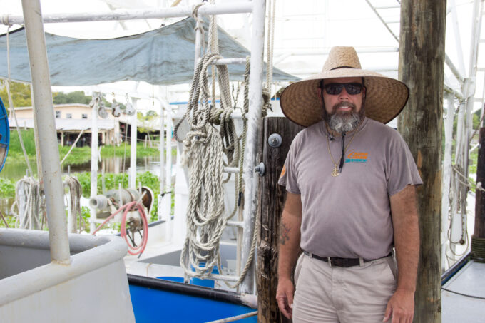 Lance Nacio stands dockside by his fishing vessel Anne Marie. (Photo credit: George Graham)